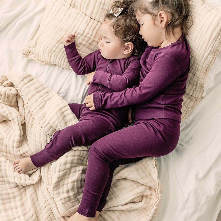 two babies sleeping with merino wool