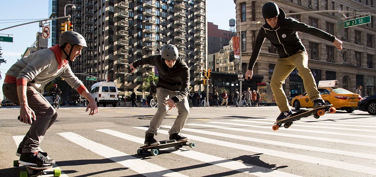 guys riding summerboards in the city 