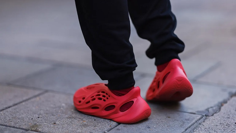 person in red adidas yeezys