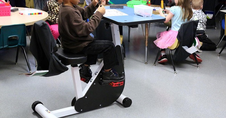 close-up of student using bicycle desk