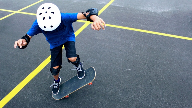 picture of a person skateboarding with a safety gear 