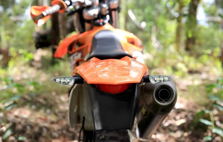 Rear view of motocross in nature with led indicators 