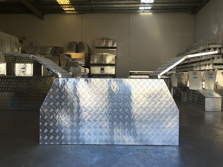 picture of aluminum gullwing canopy toolbox in storage among other aluminum boxes 