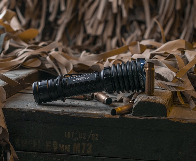 picture of a military torch beside pile of wood leftovers 