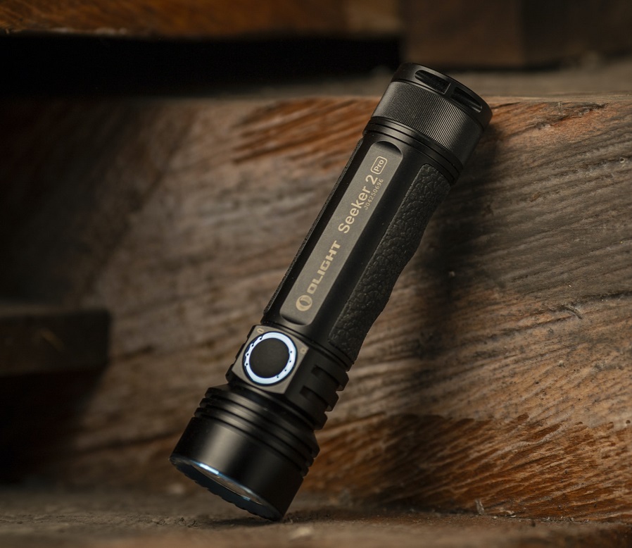 picture of a black tactical torch on wood 